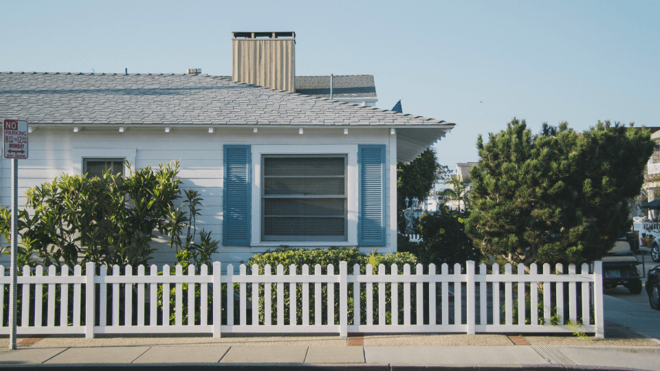 One-story house with trees and fence