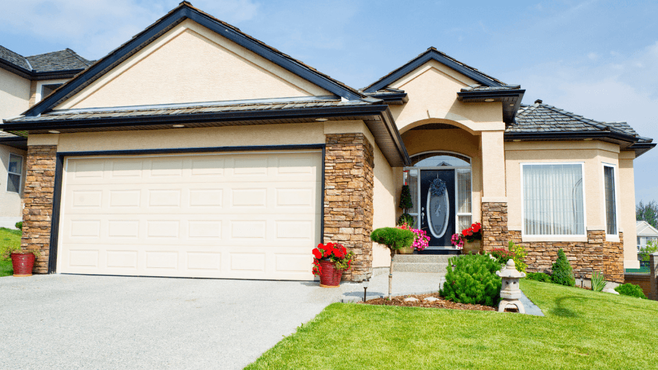 Beige house with lawn and flowers