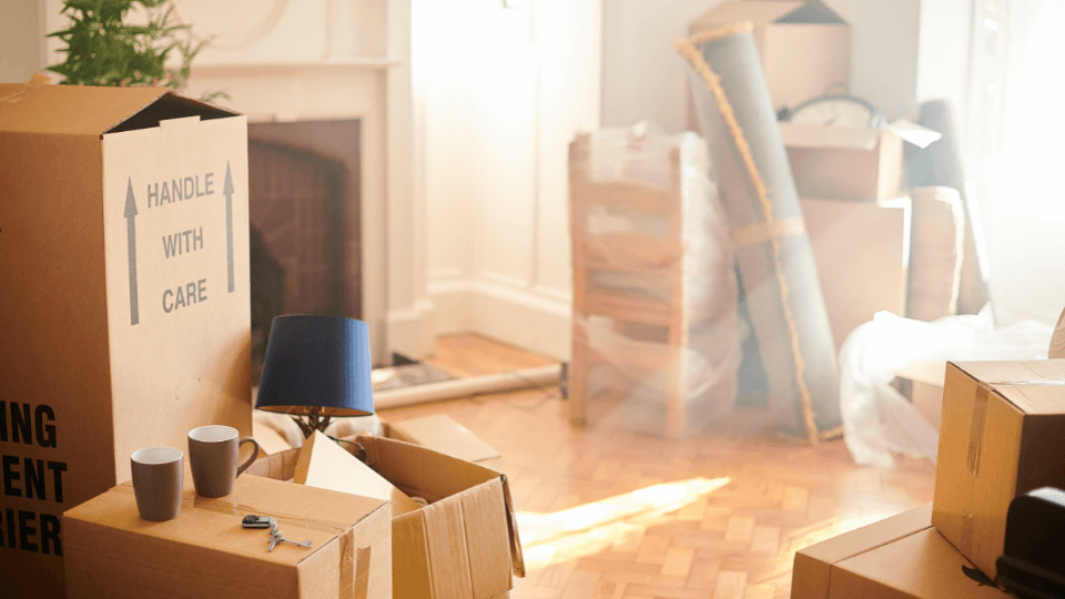 Moving boxes piled in room