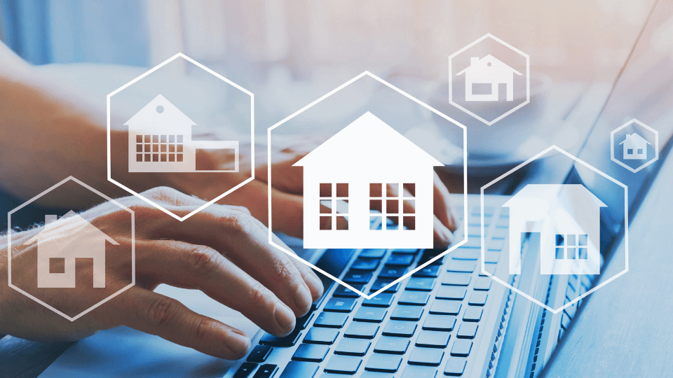 person typing on keyboard with home icons