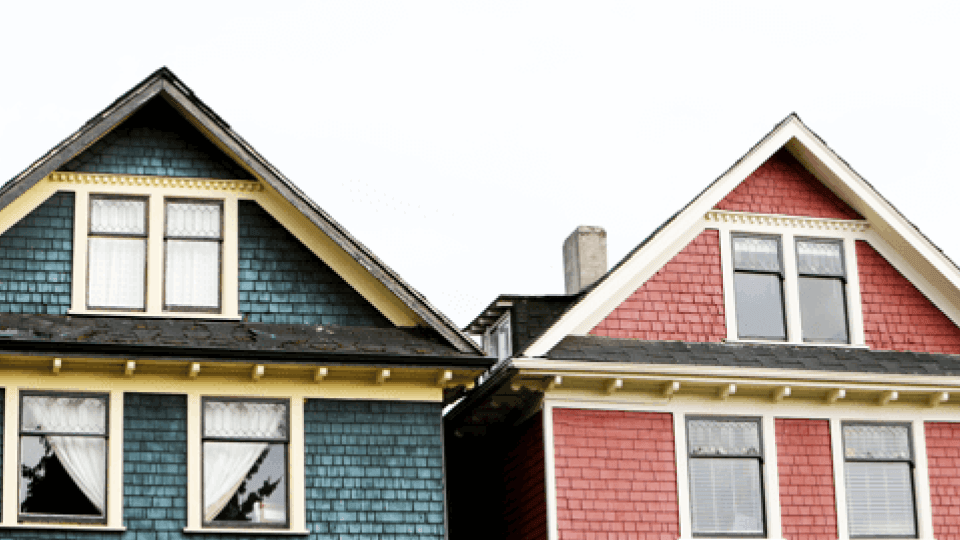 Blue and red houses next to each other