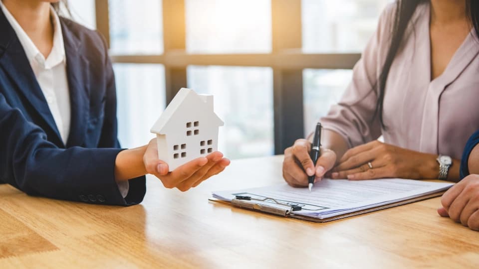 Person holding a house