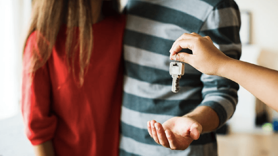 Man giving the key to the couple