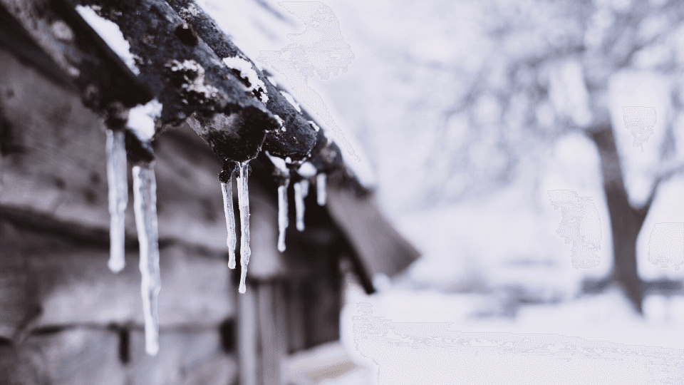 Old house wall and icicles on the roof