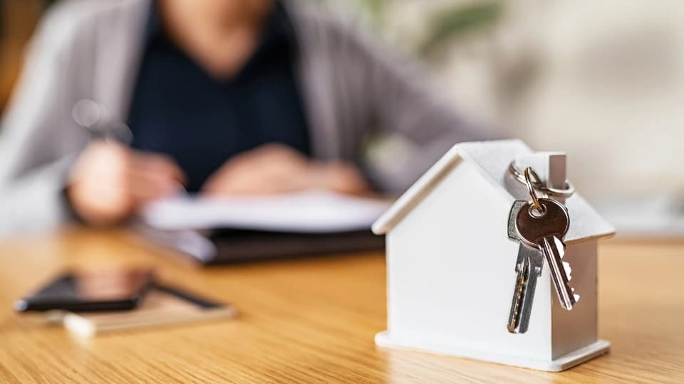 house with a set of keys on roof