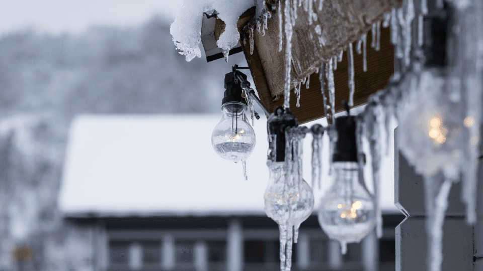 Icicles and light bulbs hang from the roof