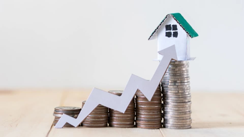 Coins with a graph arrow going up to a home