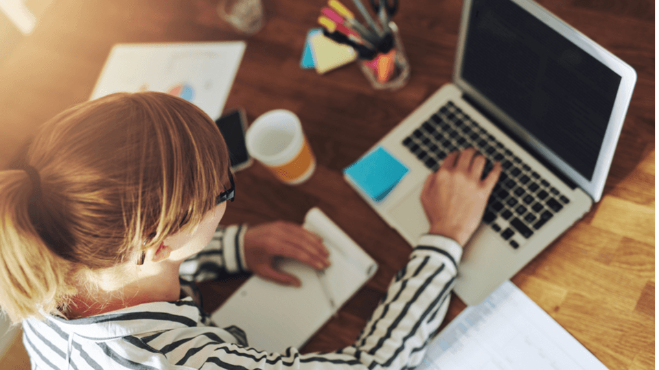 Woman at the desk working on a laptop