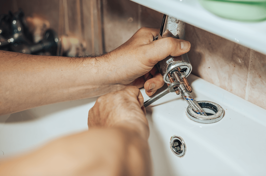 Man repairs plumbing