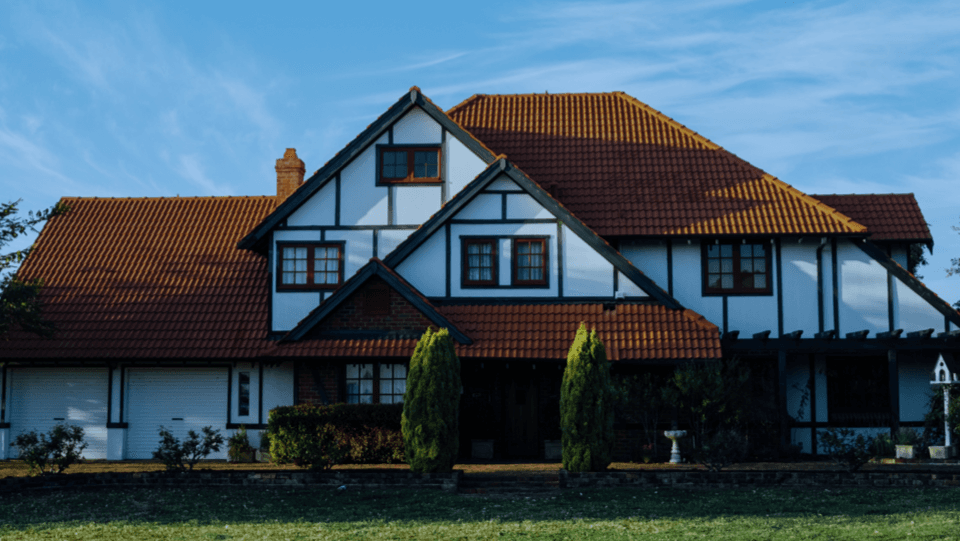 White house with dark brown roof and windows