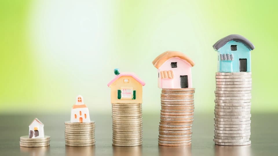 homes stacked on coins