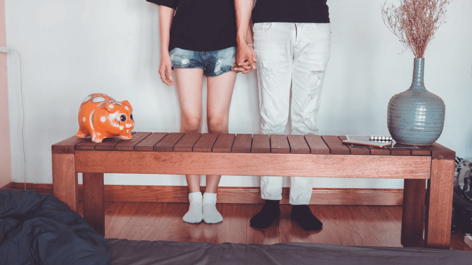 A couple standing behind the bench with decor