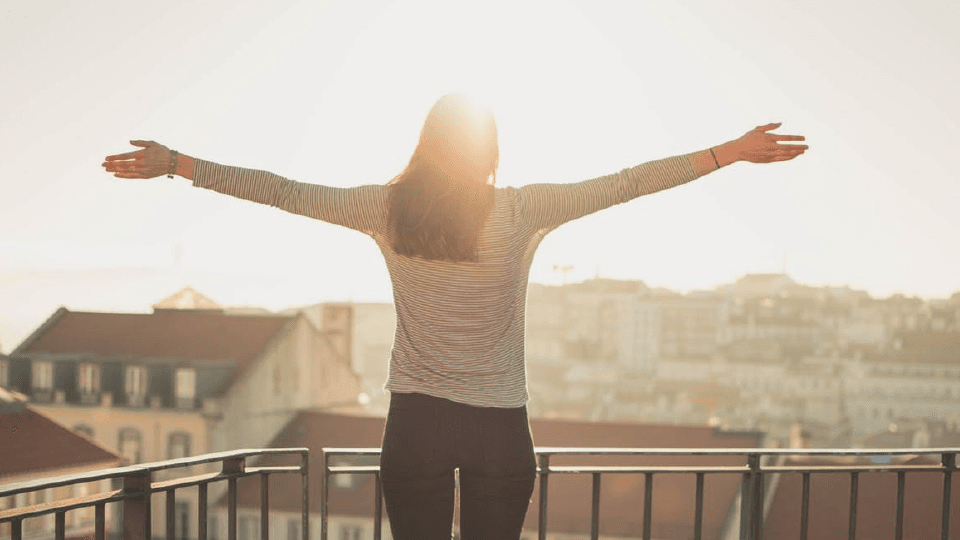 Woman on balcony with city view